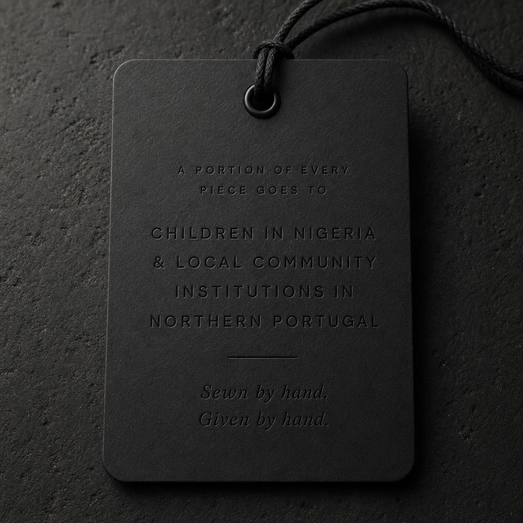 REBUILT custom-order hang tag, back — blind-debossed donation cause: children in Nigeria and local community institutions in northern Portugal